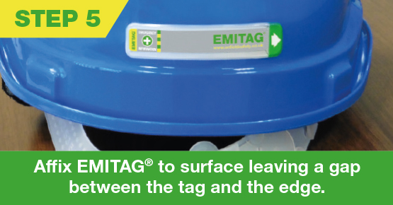 Emitag stuck to the edge of a blue hard hat