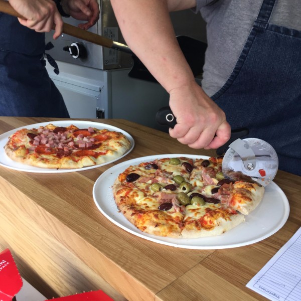 Two pizzas with hand cutting